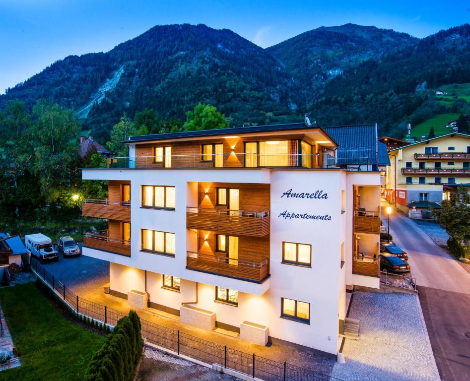 a building with a mountain in the background at Appartements Amarella in Bad Hofgastein
