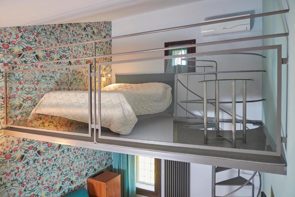 Postel nebo postele na pokoji v ubytování Ca' Masieri Hotel