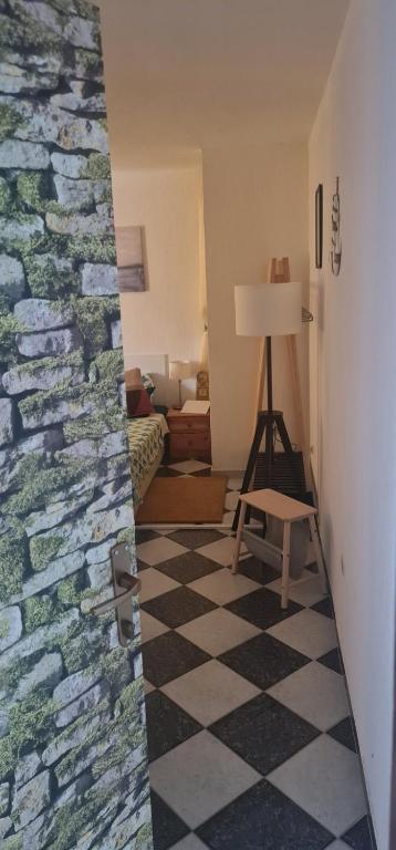 a living room with a checkered floor and a chair at Studio Prommontore in Premantura