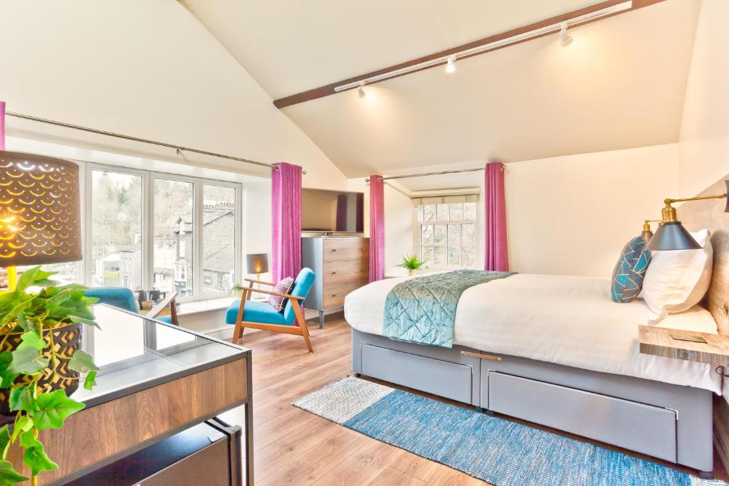 a bedroom with a king sized bed and a desk at The Apple Loft Rooms in Ambleside