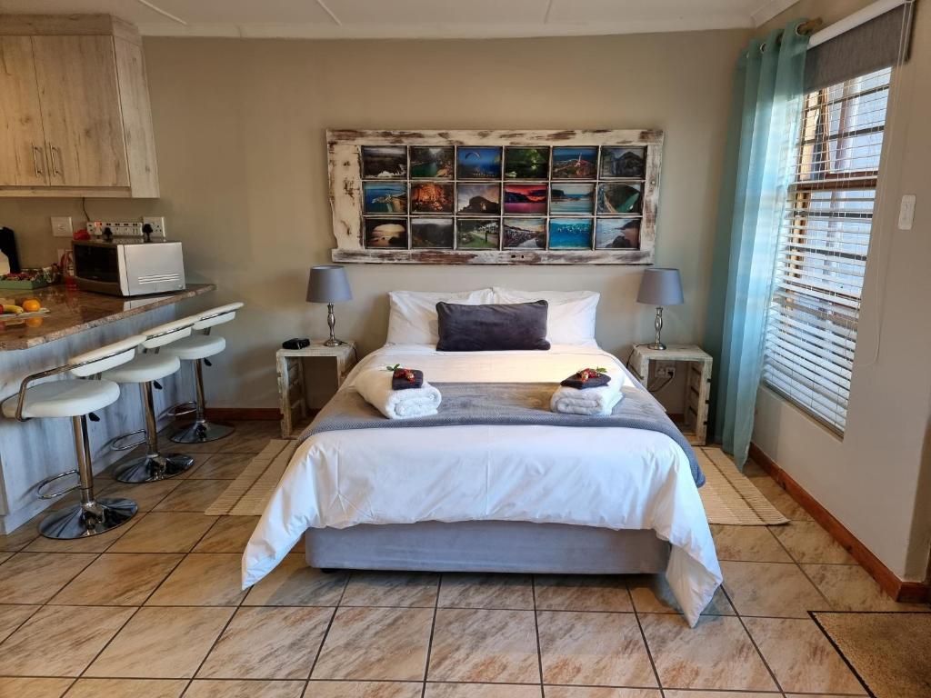 a bedroom with a bed with two stuffed animals on it at Dolphins Self-Catering Accommodation in George