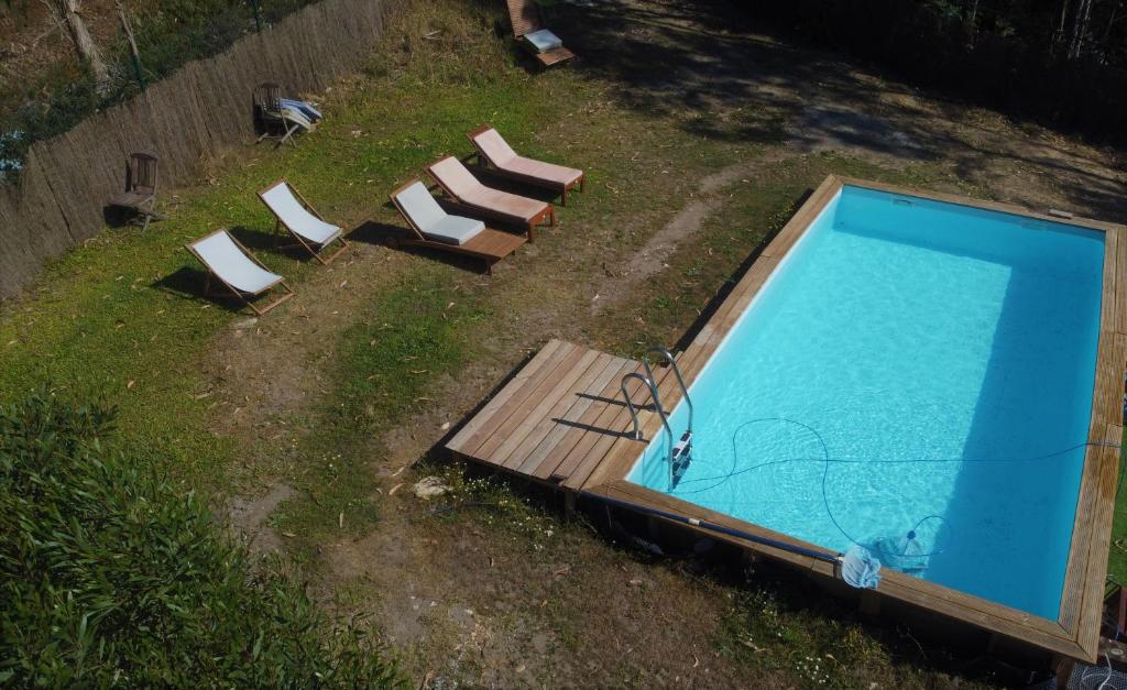 an overhead view of a swimming pool with lounge chairs at RiverHouse - Near River - Near Ocean - Near Porto in Porto
