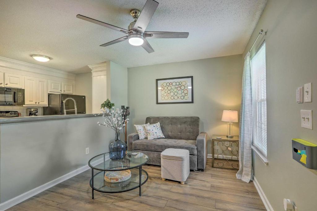 a living room with a couch and a table at Auburn Condo with 2 Pools Less Than 2 Mi to University! in Auburn