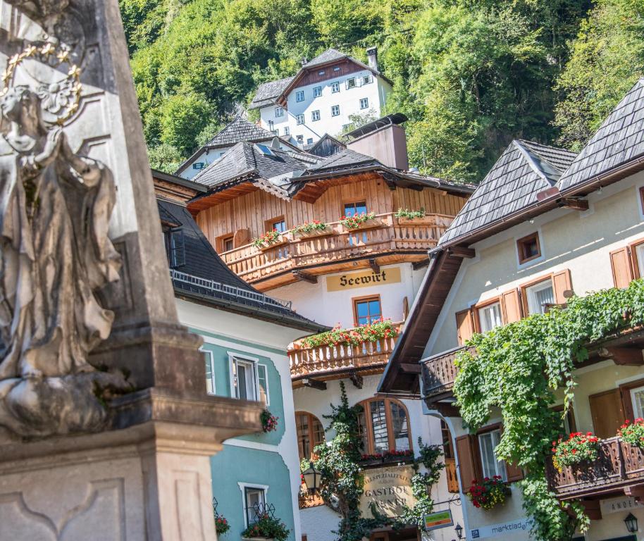 a group of houses with balconies and a mountain at Seewirt Zauner - contactless check in in Hallstatt