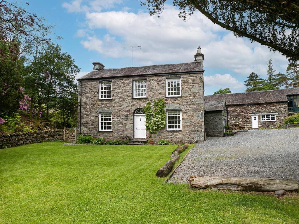 an old stone house with a large yard at Thorney How in Ambleside