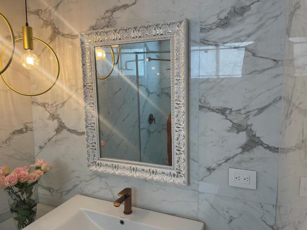 a bathroom with a mirror and a sink at PLAYA LAGUITO in Cartagena de Indias