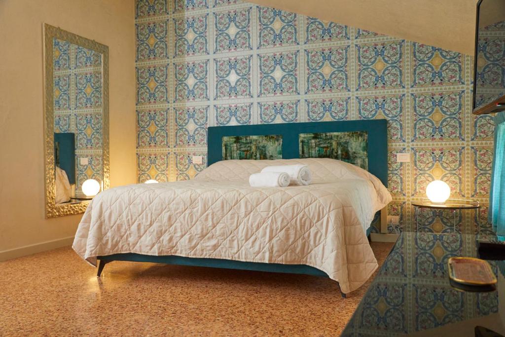 Postel nebo postele na pokoji v ubytování Ca' Masieri Hotel