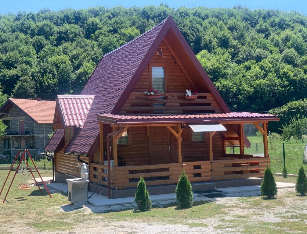 a large log cabin with a purple roof at Vikendica Bosnjak in Sarajevo