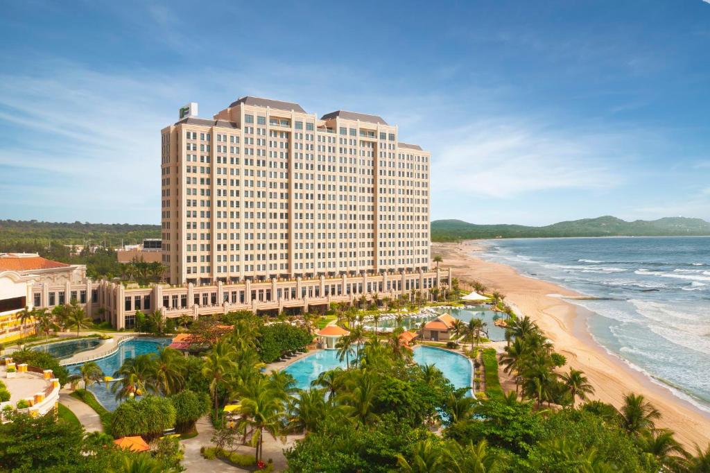 a view of a hotel and the beach at Holiday Inn Resort Ho Tram Beach by IHG in Ho Tram