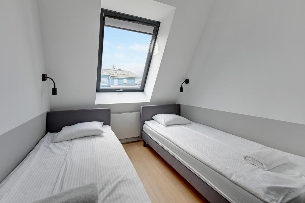 Łóżko lub łóżka w pokoju w obiekcie Baltic Lagoon - Okrzei Residence