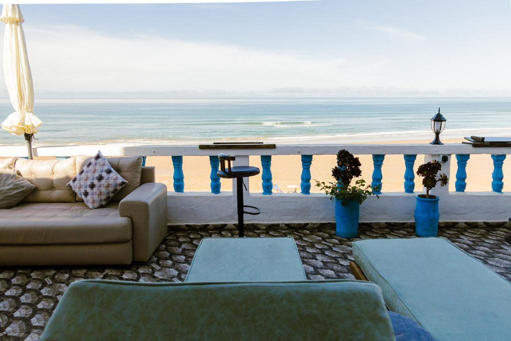 a living room with a couch and a view of the ocean at L'Auberge Taghazout in Taghazout