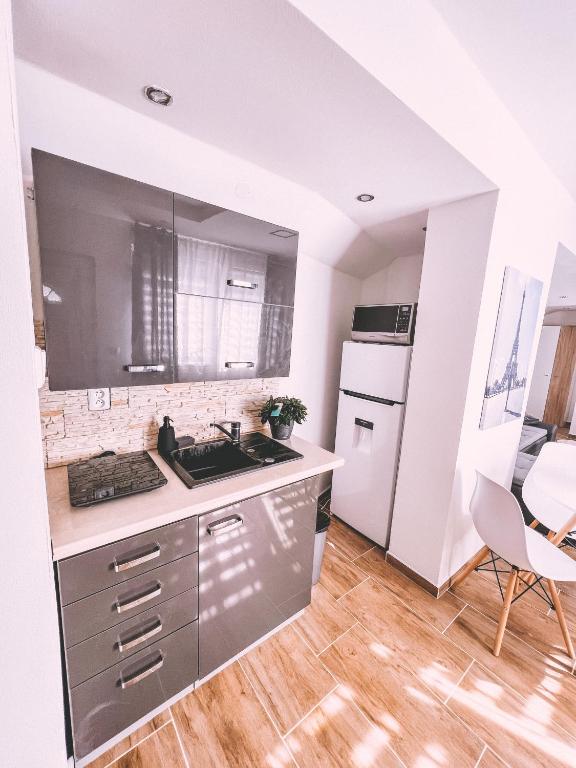 a kitchen with a sink and a stove top oven at Unicorn Hřensko in Hřensko