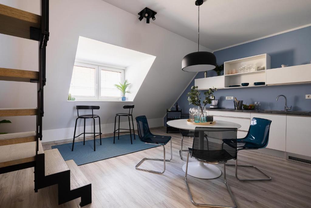 a kitchen and dining room with a table and chairs at New Central Studio with Parking in Ljubljana
