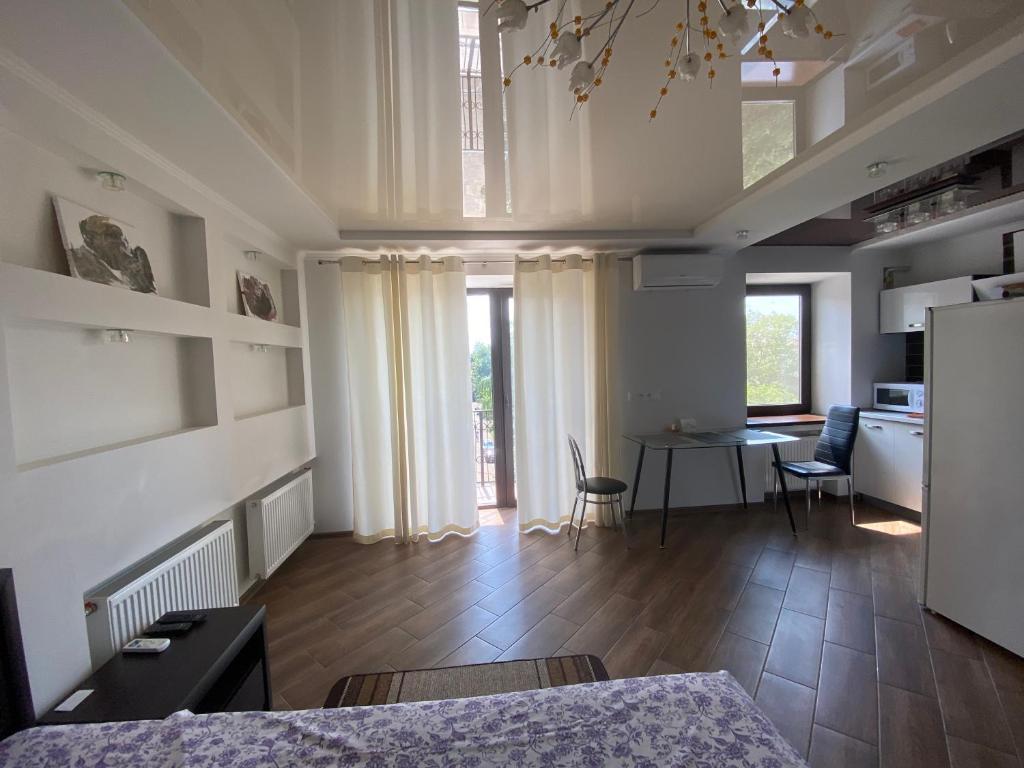 a large room with a kitchen and a dining table at 1-room Studio center in Cherkasy