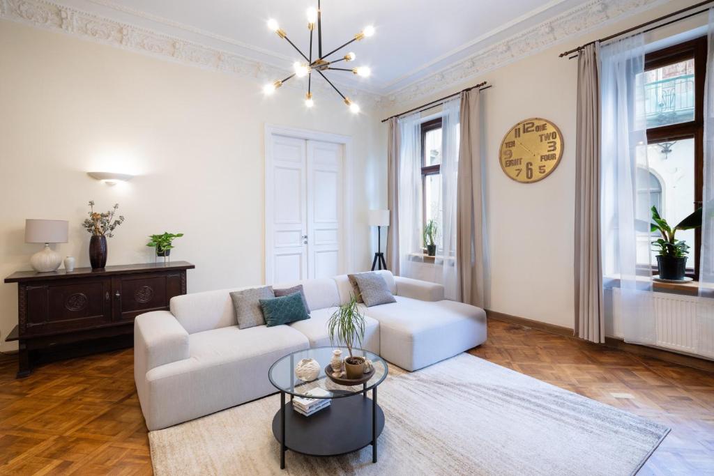 a living room with a white couch and a table at Old Riga Modern and Spacious 2 bedroom Apartment in Rīga
