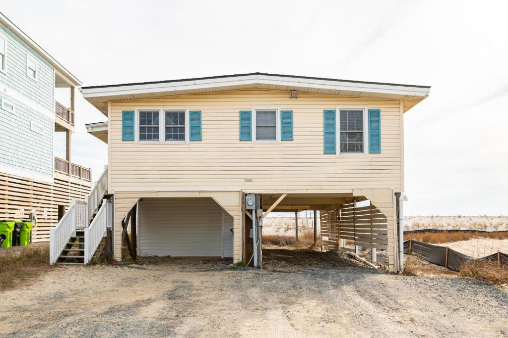 a large house with a garage in front of it at Smart Pelican by Oak Island Accommodations in Oak Island