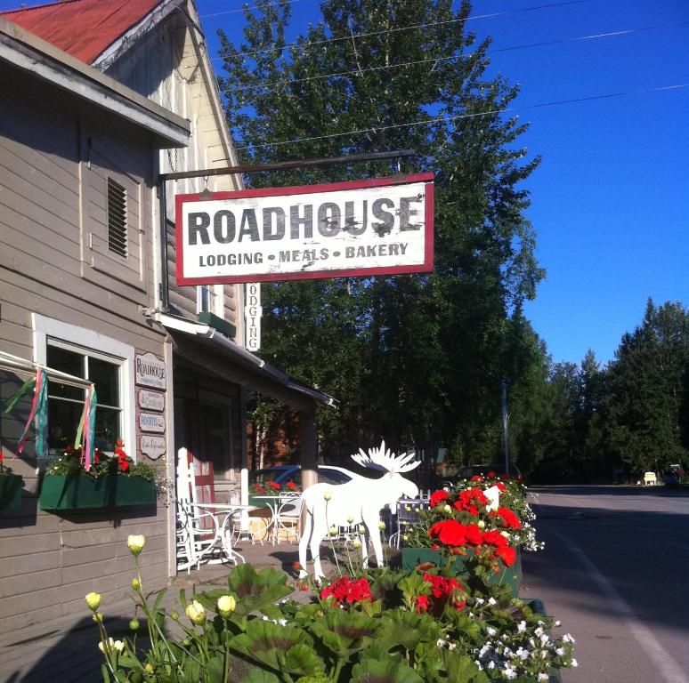 a sign for a restaurant with a statue of a horse at Talkeetna Roadhouse in Talkeetna