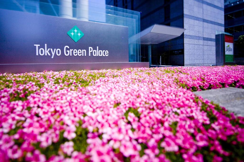 a field of pink flowers in front of a building at Tokyo Green Palace in Tokyo