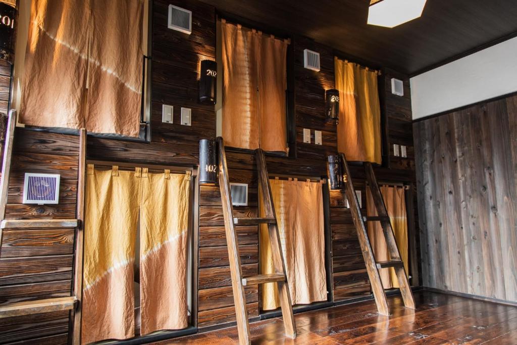 a row of ladders in a room with curtains at Hostel Knot - Vacation STAY 88773v in Izu