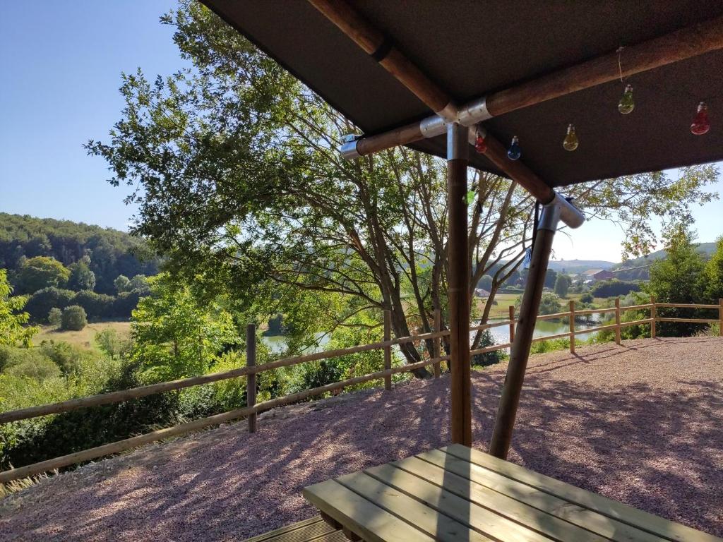 a wooden bench on a porch with a view of the mountains at Tente Medley (6p) proche Fécamp Etretat in Colleville