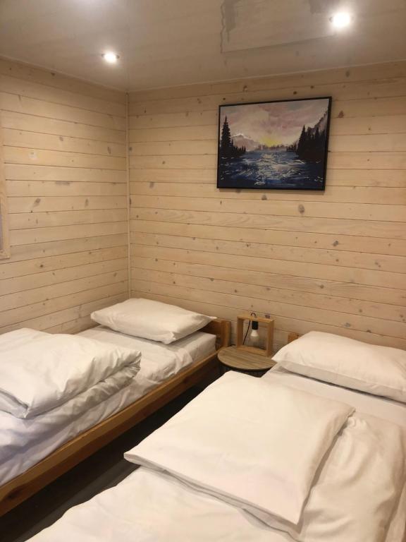 a room with two beds and a picture on the wall at Słoneczne ranczo Zator Energylandia in Zator