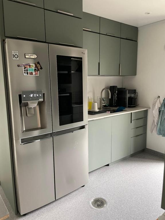 uma cozinha com armários brancos e um frigorífico em Nice apartment in the middel of Tórshavn em Tórshavn