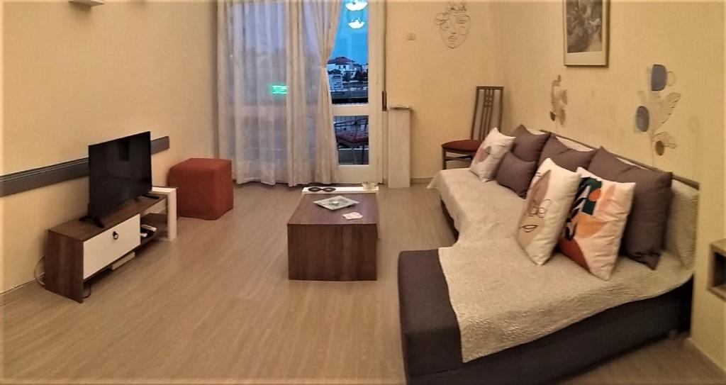 sala de estar con sofá y TV en G & G guesthouse II en Edessa