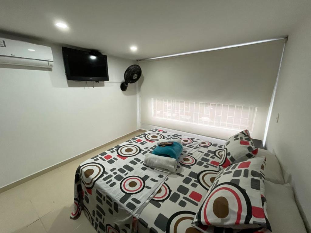 Postel nebo postele na pokoji v ubytování Lindos apartaestudios y habitaciones en Ibague