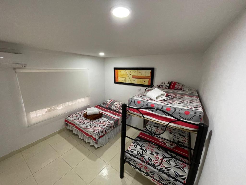 Postel nebo postele na pokoji v ubytování Lindos apartaestudios y habitaciones en Ibague