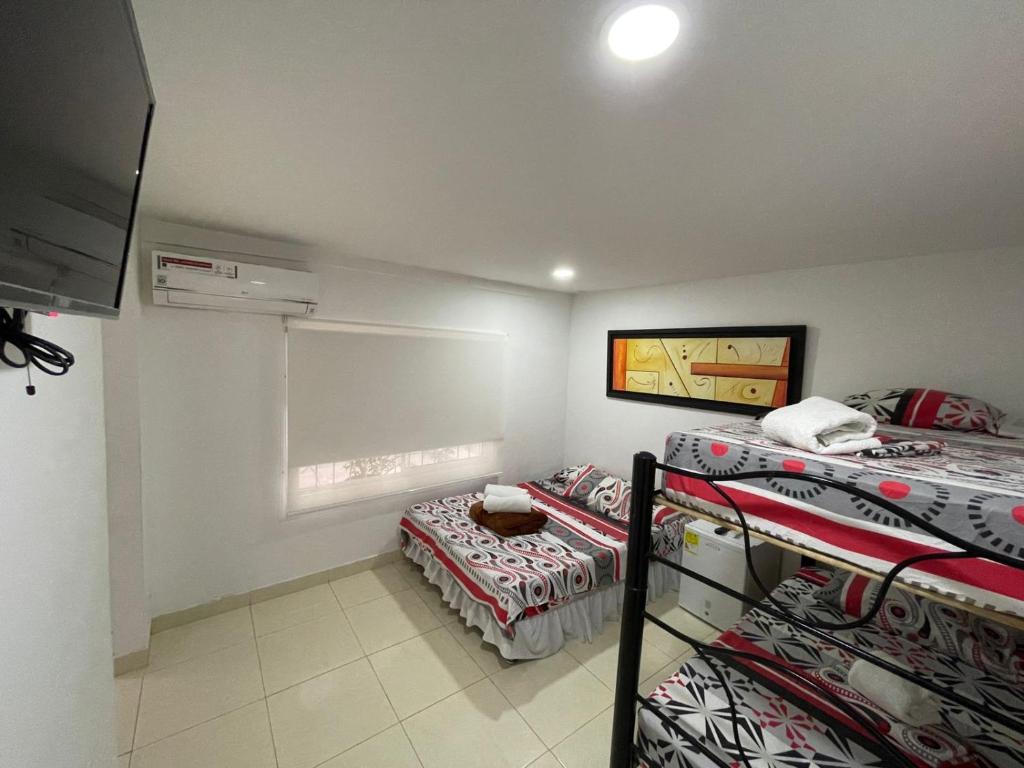 Postel nebo postele na pokoji v ubytování Lindos apartaestudios y habitaciones en Ibague