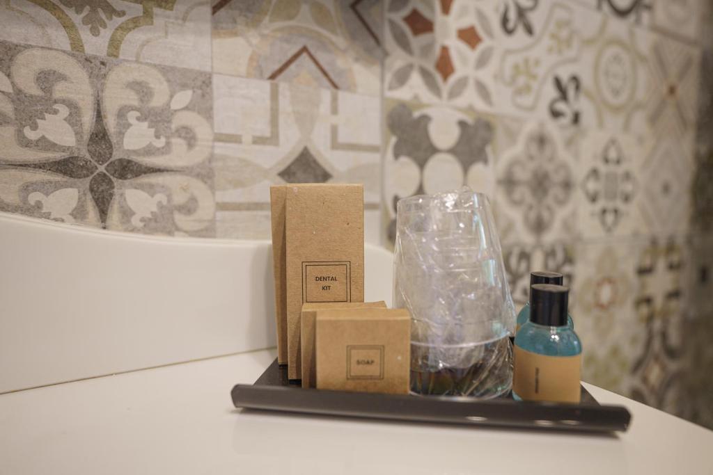 a counter with some boxes and a bottle on it at Ajuga Luxury Boutique B&B in Qala