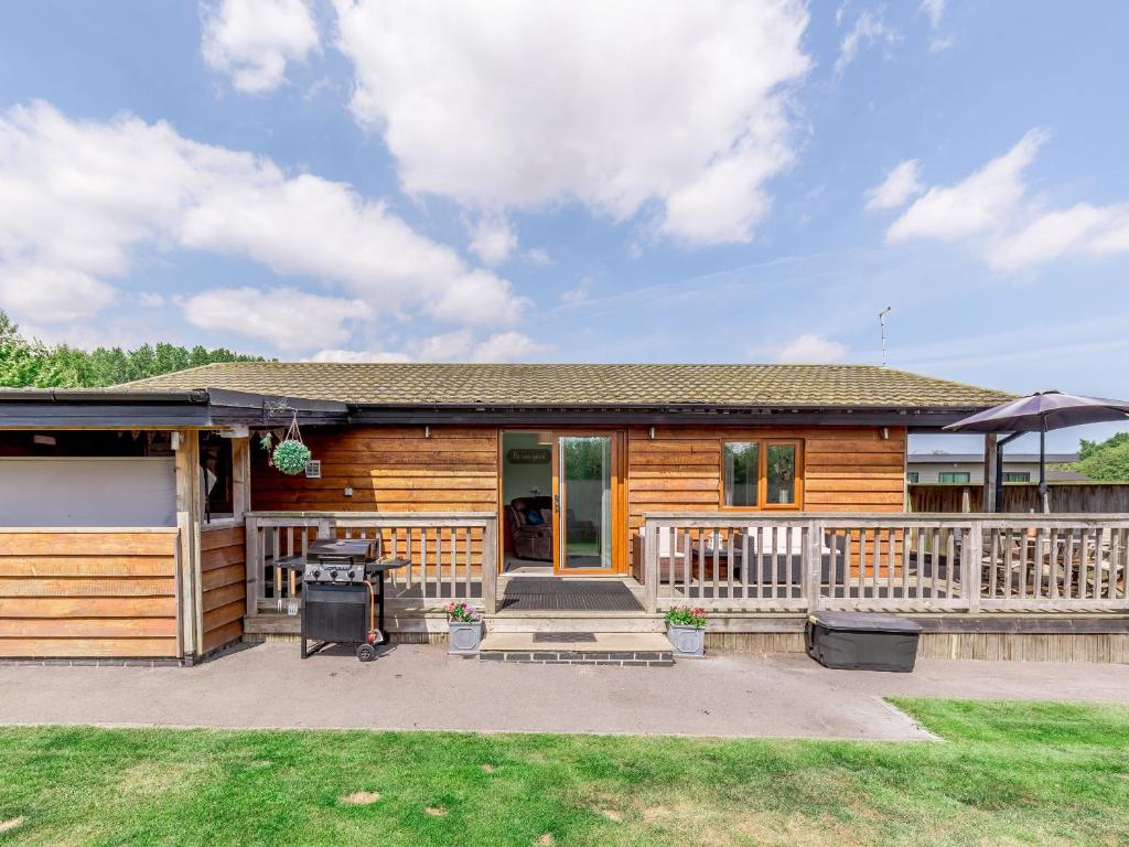 a log home with a porch and a porch at Kingfisher Lodge in Leven