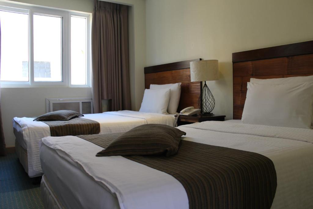 Postel nebo postele na pokoji v ubytování Boracay Sands Hotel
