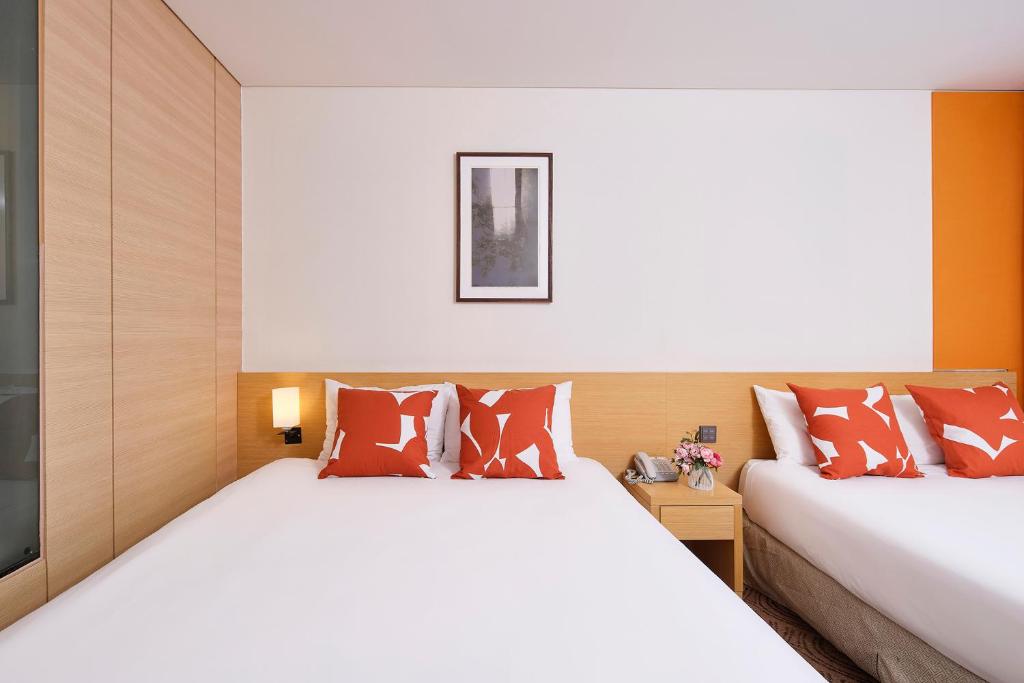 Postel nebo postele na pokoji v ubytování Jeju Central City Hotel