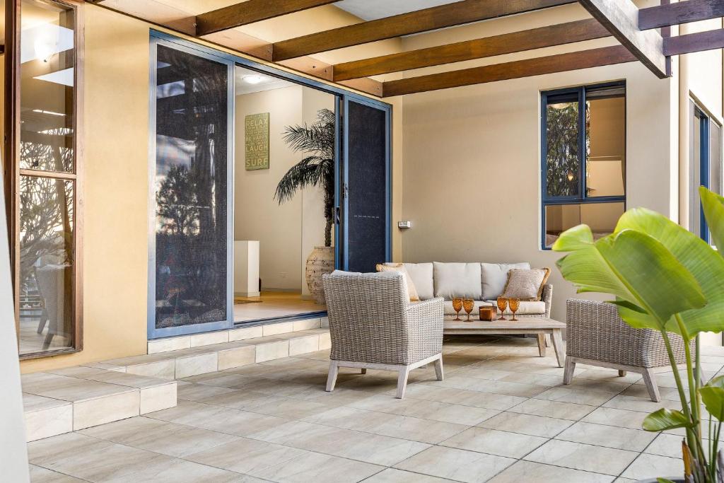een woonkamer met 2 stoelen en een bank bij Currumbin Beachside Retreat in Gold Coast