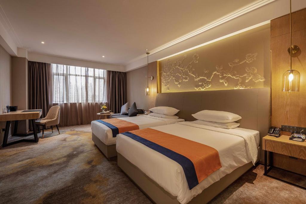 Voodi või voodid majutusasutuse Wuhan Hongguang Hotel toas