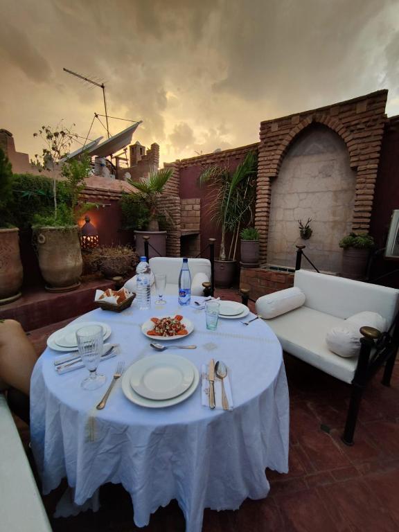 a white table with plates of food on it at Riad Assalam in Marrakech