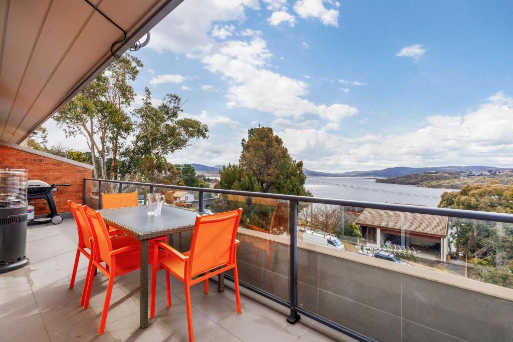 a table and chairs on a balcony with a view at Kooringa 4 in Jindabyne