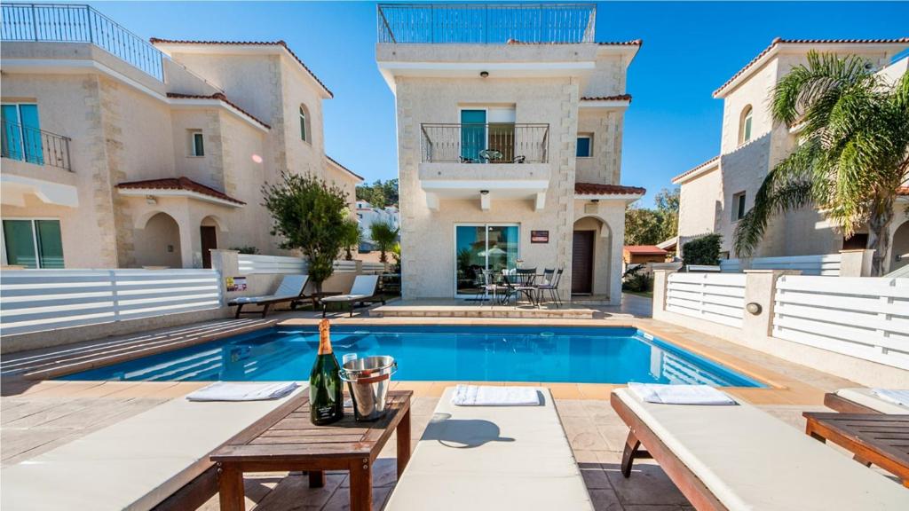 a villa with a swimming pool and a house at Protaras Holiday Villa 045 in Protaras