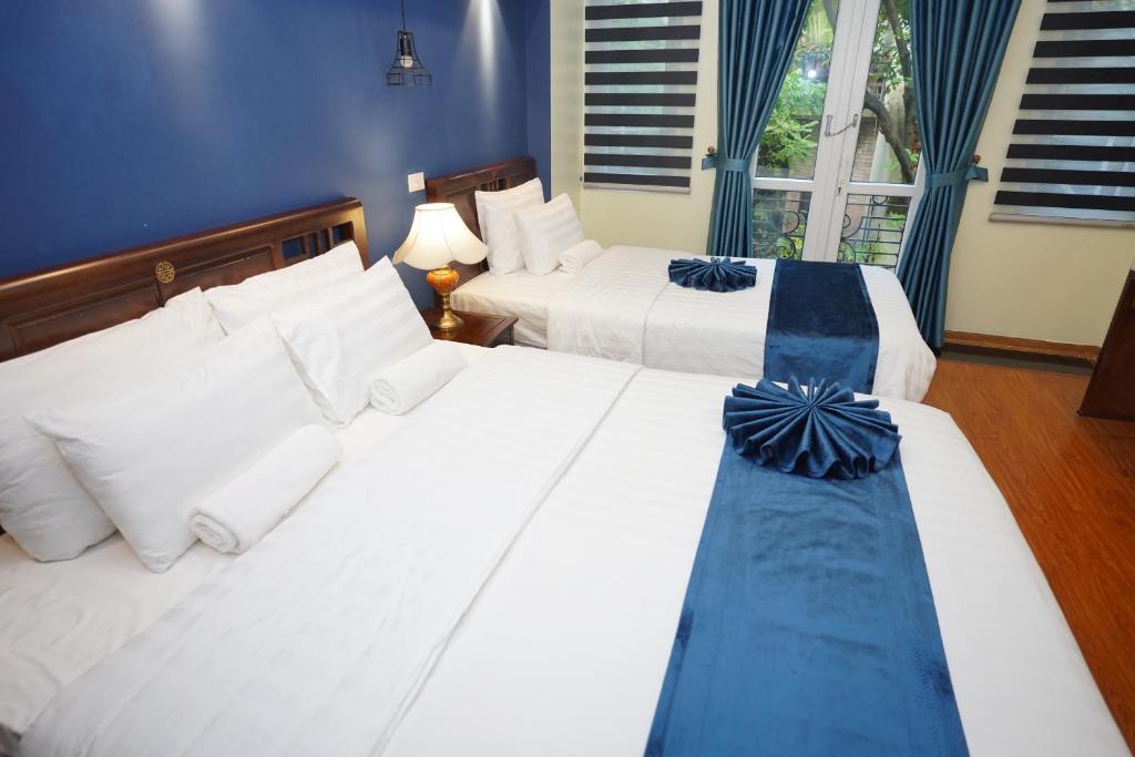 Postel nebo postele na pokoji v ubytování Hanoi Capital Premium Hotel