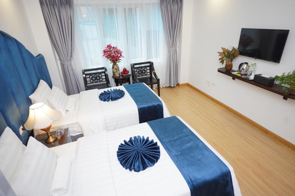 Postel nebo postele na pokoji v ubytování Hanoi Capital Premium Hotel