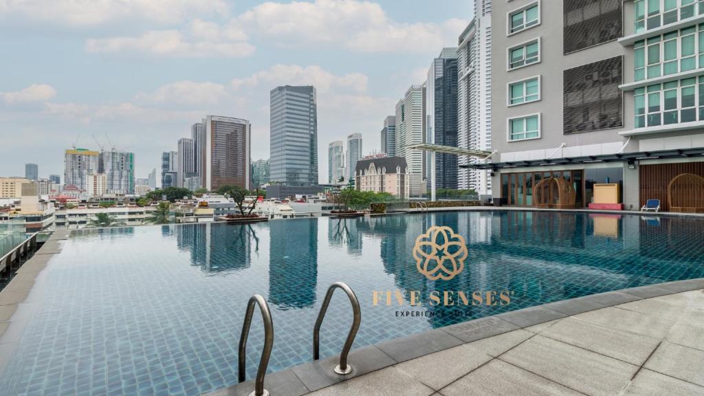 a swimming pool in a city with tall buildings at Dua Sentral Kuala Lumpur by Five Senses in Kuala Lumpur