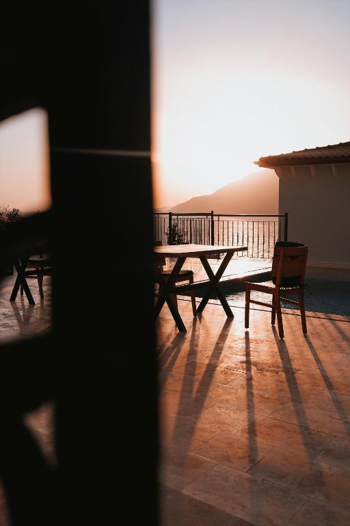 a table and chairs on a balcony with a view at Gümüş Yazar Hotel in Kaş