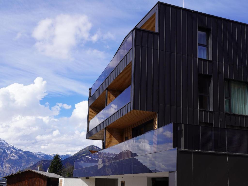 a black building with a view of the mountains at Perfect Lodgings Panorama Hart in Hart im Zillertal
