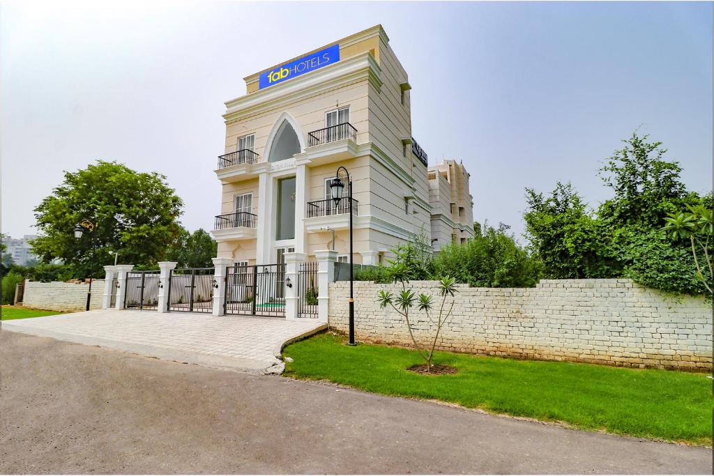 a white building with a sign on top of it at FabHotel K9 Villa in Ludhiana