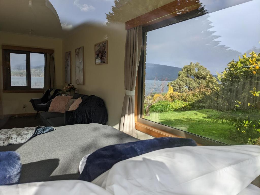 a bedroom with a large window with a view at Smugglers Rest Apartments Dover in Dover