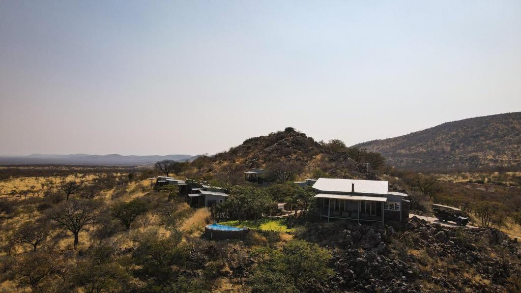 an aerial view of a house on a hill at Mountain Peak Game Lodge and Camping in Ozongaka