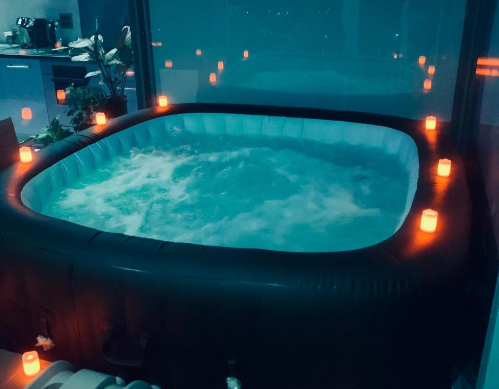 a hot tub with lights in a room at Luxury 9ine PENTHOUSE WITH GARDEN & JACUZZI in Birmingham