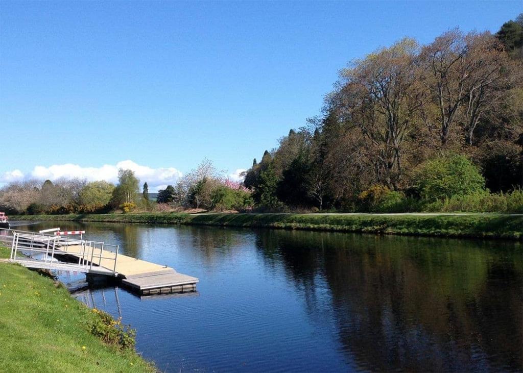 a river with a dock on the side of it at Torvean Holiday Park in Inverness