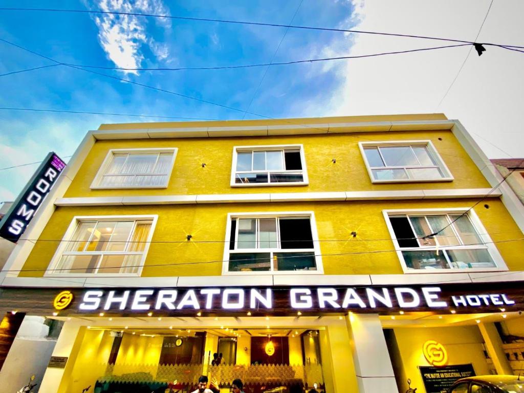a yellow building with araction grande written on it at Sheraton Grande Hotel - Business Class Hotel - Near Central Railway Station in Chennai